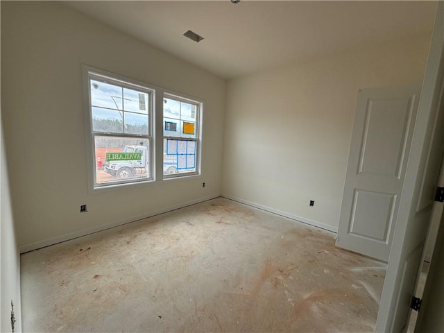 spare room with baseboards