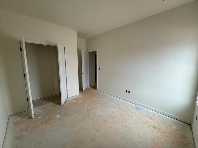 unfurnished bedroom with concrete floors