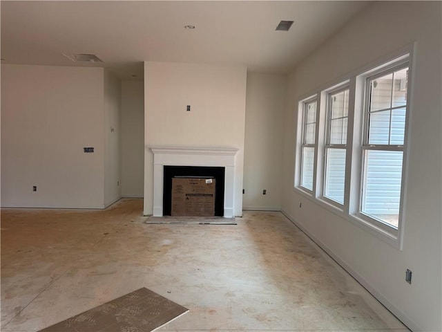 unfurnished living room with baseboards, a fireplace, and visible vents