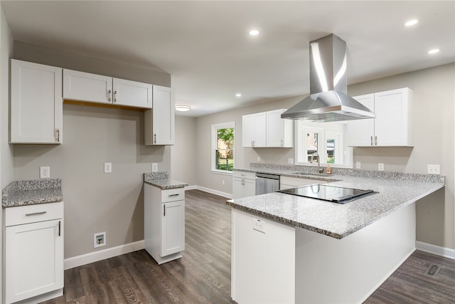 kitchen featuring dishwasher, dark wood-type flooring, black electric cooktop, island range hood, and white cabinets