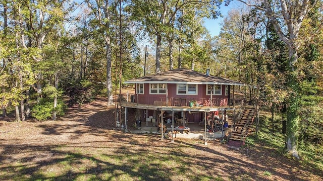 back of property featuring a patio area and a wooden deck