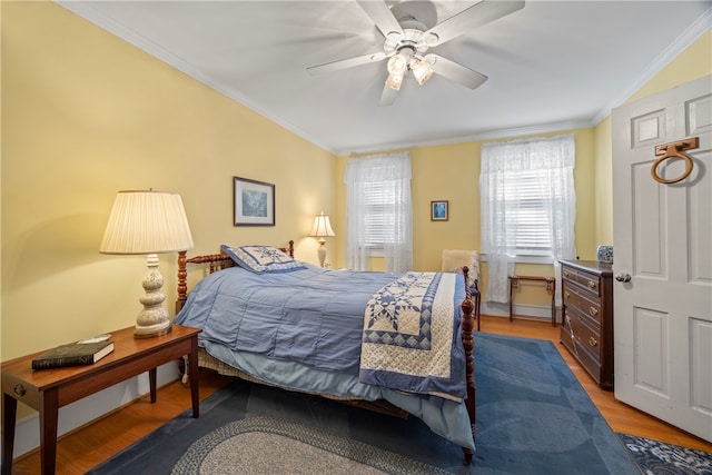 bedroom with ceiling fan, light hardwood / wood-style floors, and ornamental molding