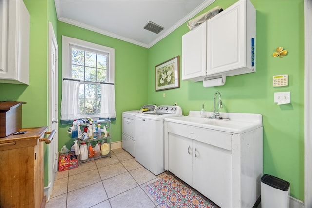 laundry room featuring cabinets, light tile patterned floors, washer and dryer, and ornamental molding