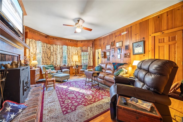 living room featuring ceiling fan and a healthy amount of sunlight