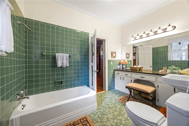 full bathroom with vanity, crown molding, tiled shower / bath combo, toilet, and tile walls