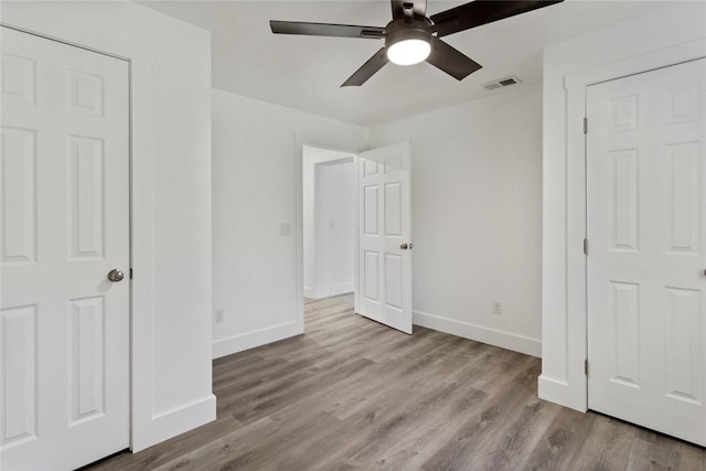 unfurnished bedroom featuring light wood-type flooring and ceiling fan