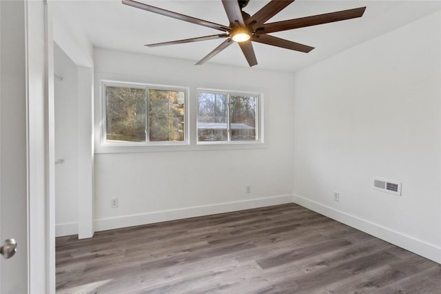 empty room featuring ceiling fan and dark wood-type flooring