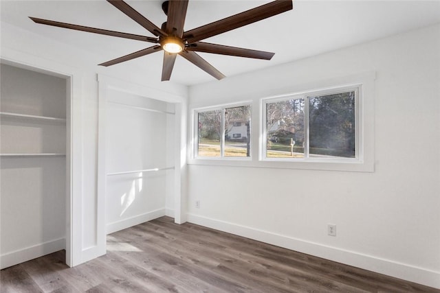 unfurnished bedroom with ceiling fan and hardwood / wood-style flooring