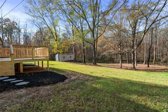 view of yard featuring a shed and a deck