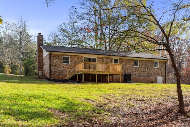 rear view of property with a yard, central AC unit, and a wooden deck