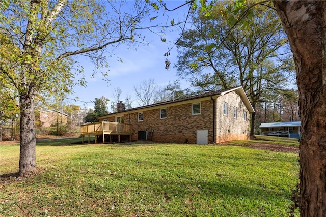 rear view of house featuring a lawn, a deck, and central air condition unit