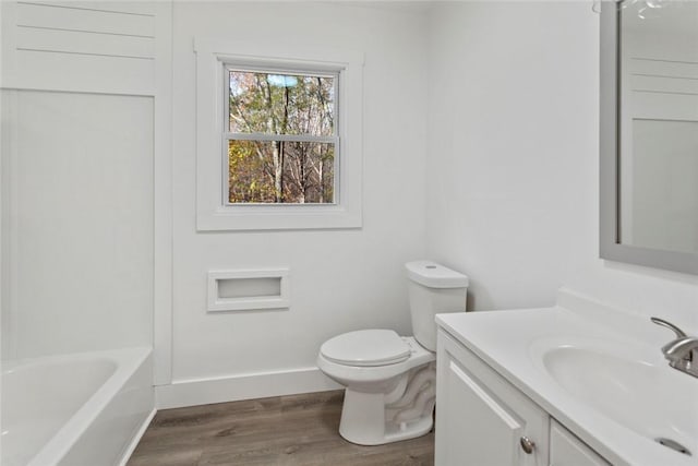 full bathroom with shower / tub combination, hardwood / wood-style floors, vanity, and toilet