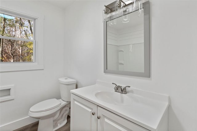 bathroom featuring hardwood / wood-style flooring, vanity, and toilet