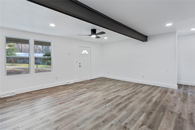 spare room with ceiling fan, beam ceiling, and light hardwood / wood-style floors