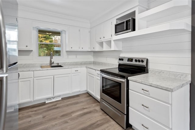 kitchen with crown molding, sink, light hardwood / wood-style flooring, appliances with stainless steel finishes, and white cabinetry