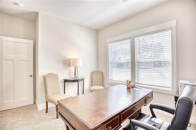 carpeted home office with a healthy amount of sunlight