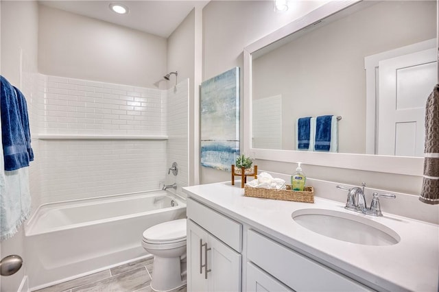 full bathroom featuring vanity, toilet, and tiled shower / bath combo