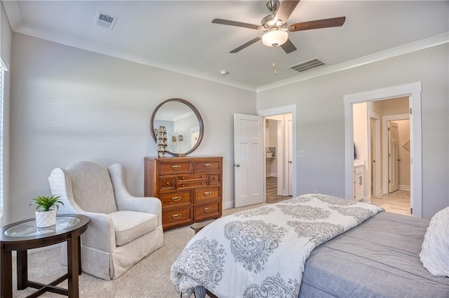 bedroom with crown molding, ceiling fan, ensuite bathroom, and light carpet