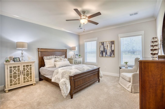 bedroom featuring crown molding, light colored carpet, and ceiling fan