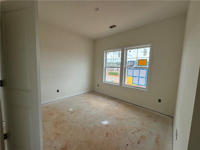 unfurnished room featuring visible vents