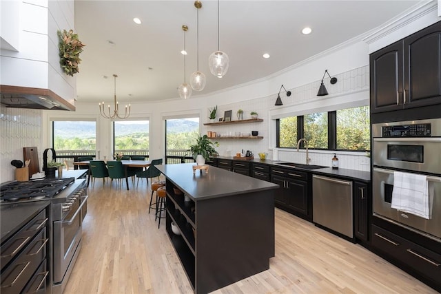 kitchen featuring a kitchen island, ornamental molding, stainless steel appliances, and a wealth of natural light