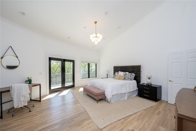 bedroom with french doors, light wood-type flooring, access to outside, high vaulted ceiling, and an inviting chandelier