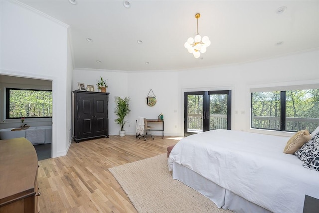 bedroom with access to exterior, light wood-type flooring, an inviting chandelier, and ornamental molding