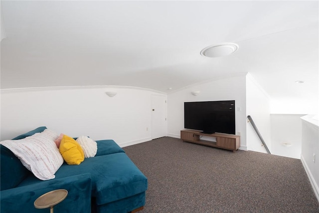 carpeted living room featuring crown molding and lofted ceiling