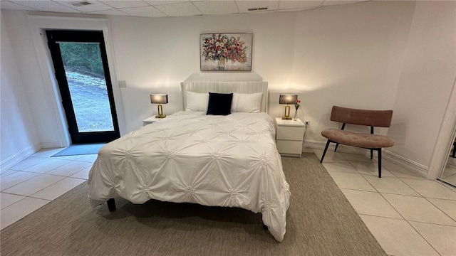 tiled bedroom with a drop ceiling