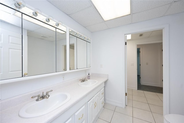 bathroom with tile patterned floors, a paneled ceiling, and vanity