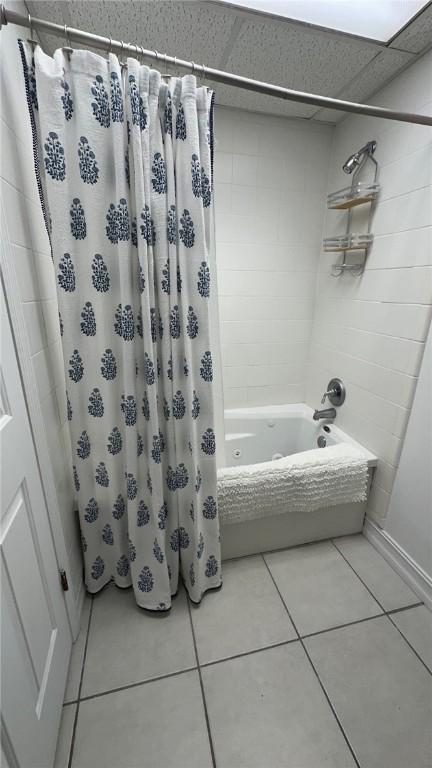 bathroom featuring tile patterned flooring and shower / bath combination with curtain