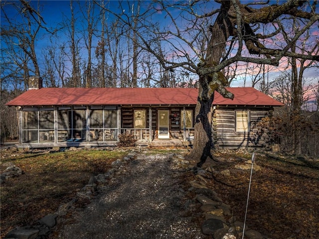 view of front of house with a sunroom