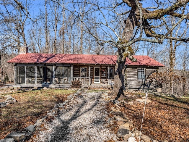 single story home featuring a sunroom