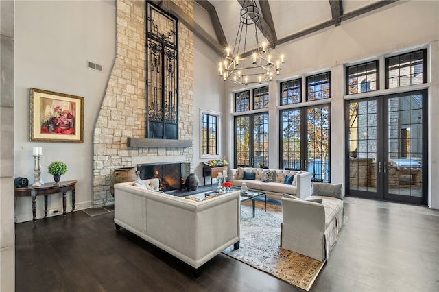 living room with hardwood / wood-style flooring, a fireplace, high vaulted ceiling, and french doors