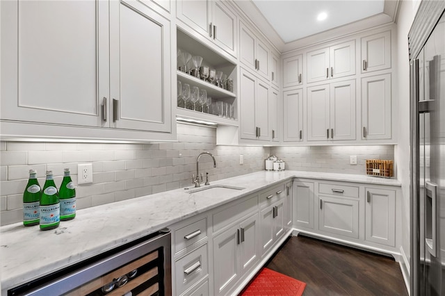 kitchen featuring white cabinets, sink, beverage cooler, and dark wood-type flooring