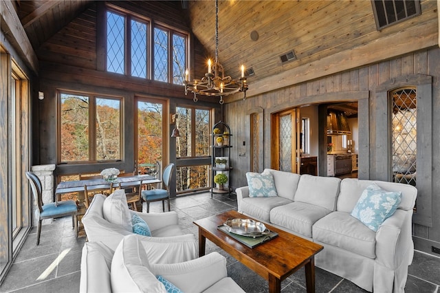 sunroom featuring wood ceiling, a notable chandelier, lofted ceiling, and a wealth of natural light