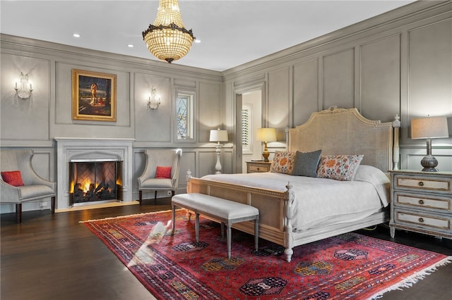 bedroom featuring dark hardwood / wood-style flooring and a notable chandelier