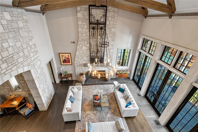 living room with beam ceiling, high vaulted ceiling, and wood-type flooring