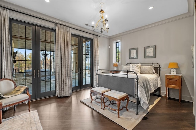 bedroom featuring french doors, dark wood-type flooring, an inviting chandelier, access to outside, and ornamental molding