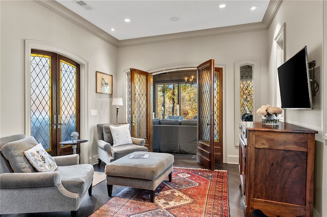 sitting room featuring french doors, dark hardwood / wood-style flooring, and crown molding