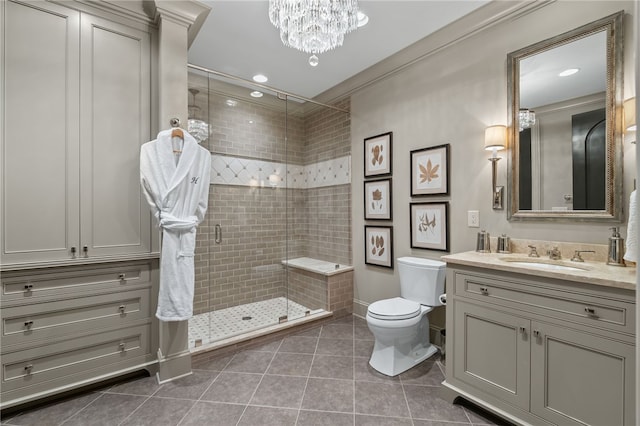 bathroom with tile patterned floors, walk in shower, vanity, crown molding, and toilet