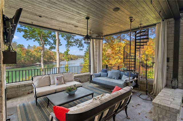 sunroom featuring ceiling fan, a water view, and wooden ceiling