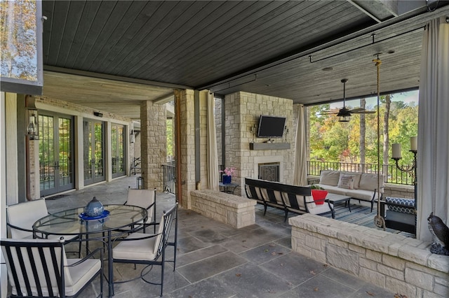 view of patio / terrace with an outdoor living space with a fireplace