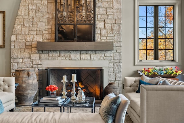 living room featuring a stone fireplace