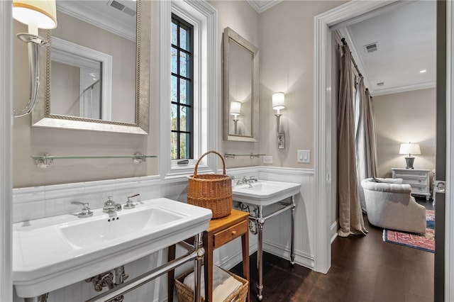 bathroom with double sink, hardwood / wood-style flooring, and ornamental molding