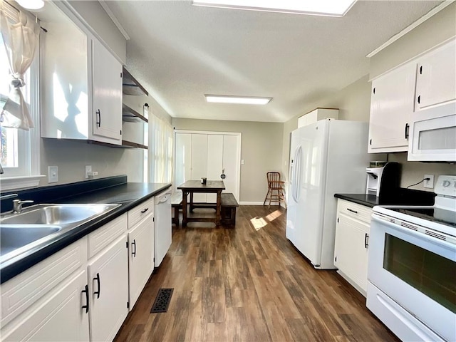 kitchen featuring dark hardwood / wood-style flooring, white appliances, white cabinetry, and sink