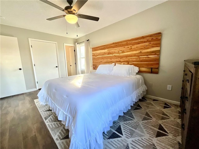 bedroom with ceiling fan and dark wood-type flooring