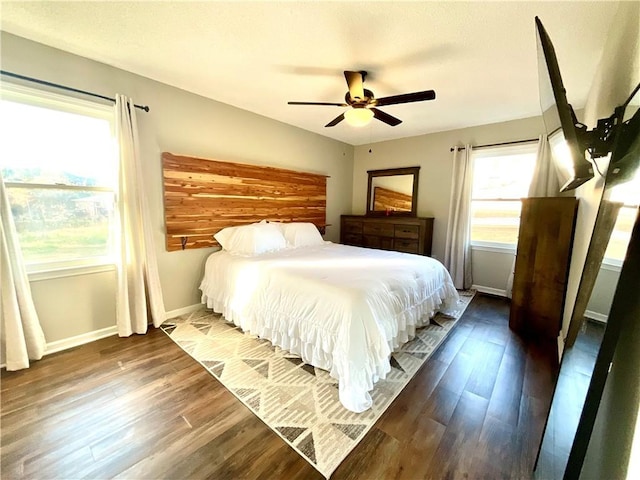 bedroom with ceiling fan and dark hardwood / wood-style flooring