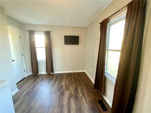 spare room featuring dark wood-type flooring