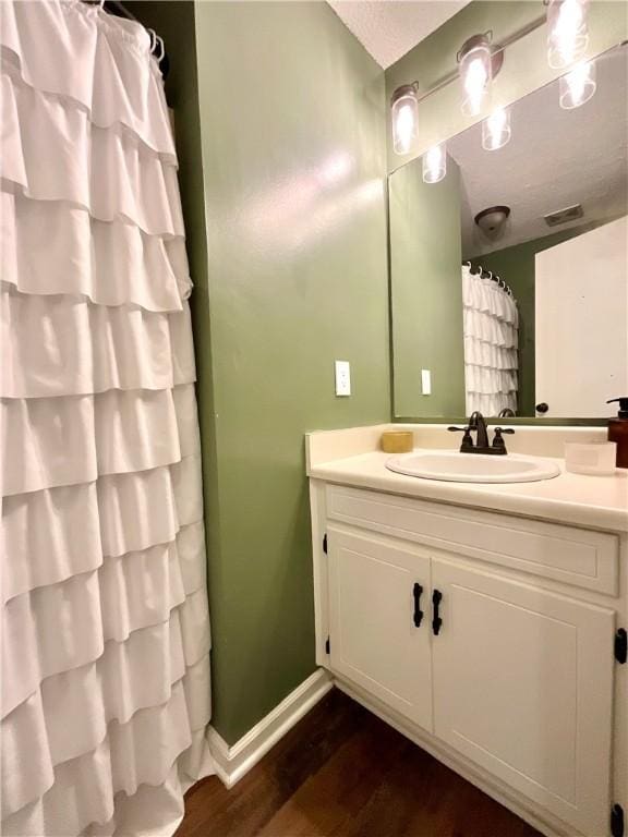 bathroom featuring hardwood / wood-style floors and vanity